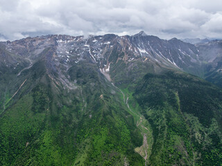 Aerial View of Green Mountain Range with Patches of Snow