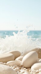 Sea wave bursts on smooth beach stones. Ocean water splashes onto white rocks. Turquoise sea and sky on the horizon. Sunny day at the shore.
