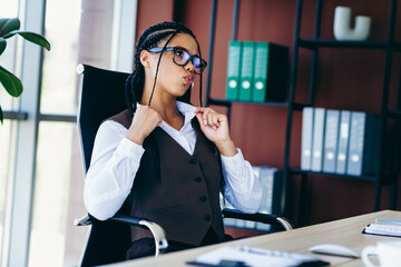 Confident businesswoman at desk in stylish office interior showcasing professionalism and charisma