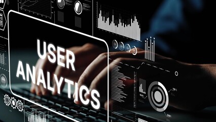 Close-up of Hands Typing on Keyboard with User Analytics Displayed on a Futuristic Screen with...