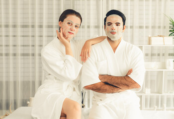 Serene modern daylight ambiance of spa salon, couple customer indulges in rejuvenating with facial...