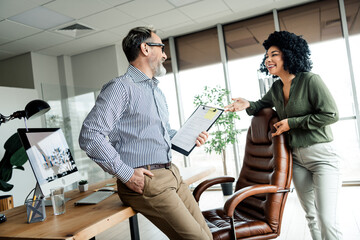 Professional collaboration between colleagues discussing a project in a well-designed and modern...