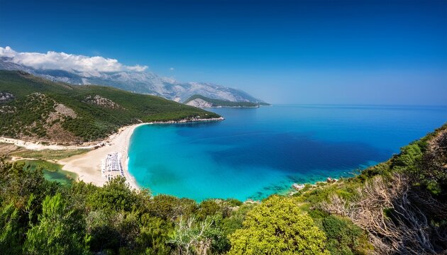 the albanian riviera on a bright spring daytime turquoise waters and sandy beaches vibrant green vegetation