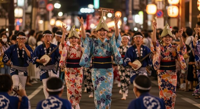 Group of Japanese people in traditional yukata performing a cultural dance at a summer street festival at night