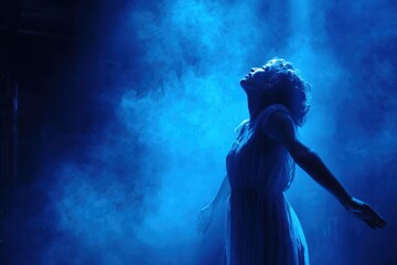 Obraz premium Actress performs emotions under blue stage lighting