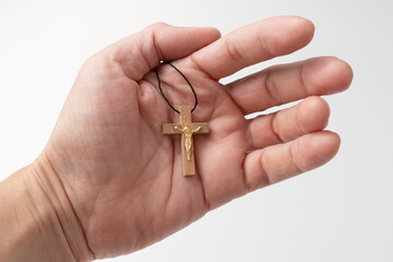 Orthodox cross in the hand of a man. The concept of faith and Christianity.