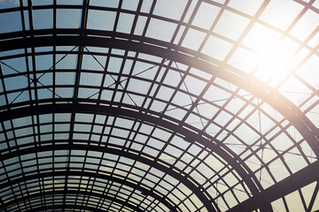 Glass roof construction detail. Transparent ceiling with metal grid and sunlight. Modern...