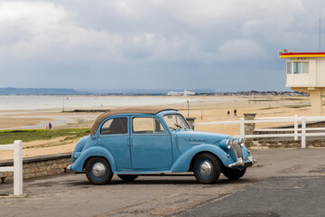 Light blue Simca 8 retro car along th beach during D-day in Normandy. Car was sold in France...