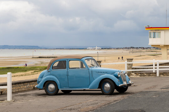 Light blue Simca 8 retro car along th beach during D-day in Normandy. Car was sold in France between 1937 and 1951.