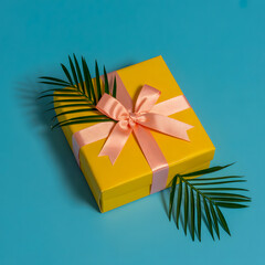 A yellow box with a pink ribbon on top of a blue background