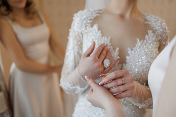 Bridal preparation in elegant setting with bridesmaids helping before the ceremony