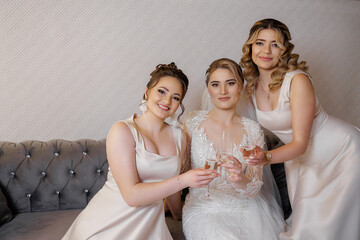 Friends celebrate together in elegant dresses during a joyful bridal moment