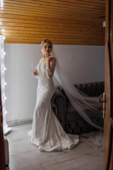 Bride preparing for her wedding in a cozy venue with elegant decor and soft lighting