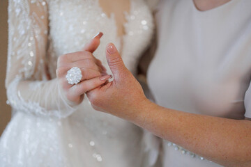 Jewelry exchange moment during a wedding celebration with family member in a warm setting