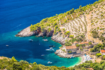 Aerial photo of Dubovica Beach on Hvar Island, Croatia, showing a serene cove with crystal-clear...