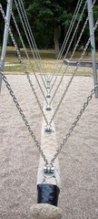Swing, balance track with chains on the playground: perspective