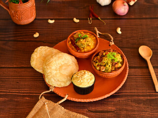Luchi, Mix Vegetable and Dal Breakfast. Delicious Ethiopian food served in traditional clay pots...