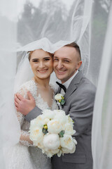 Joyful couple celebrating their wedding ceremony outdoors on a cloudy day