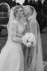 Couple celebrates their wedding day in an outdoor garden during a romantic moment