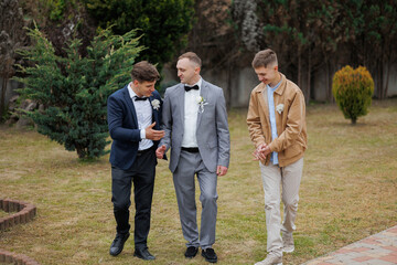 Friends celebrating a wedding in a garden setting during the afternoon