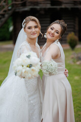 Two bridesmaids celebrate joyfully in a garden during a wedding ceremony in springtime