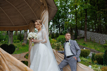 Couple celebrates their wedding day in an elegant outdoor setting surrounded by nature