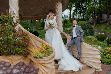 Couple posing in a scenic garden during their wedding celebration in early spring