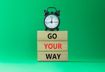 Go Your Way symbol. Wooden blocks with words Go Your Way. Beautiful green background with alarm...