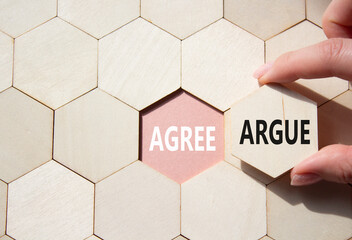 Agree or Argue symbol. Concept word Agree or Argue on wooden comb puzzle. Businessman hand....