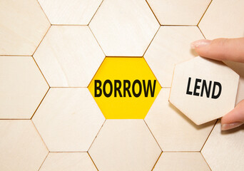 Lend or Borrow symbol. Concept word Lend or Borrow on wooden comb puzzle. Businessman hand....