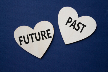 Future or Past symbol. Concept word Future or Past on wooden hearts. Beautiful deep blue...