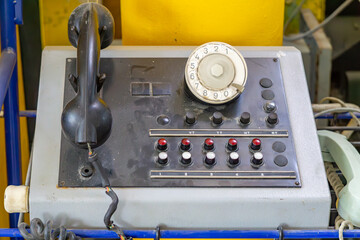 Vintage telephone switchboard with rotary dial and handset, used for manual call routing in an...