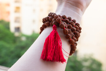  Japamala on the hand. Prayer beads. Religious equipment