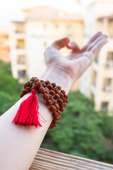  Japamala on the hand. Prayer beads. Religious equipment