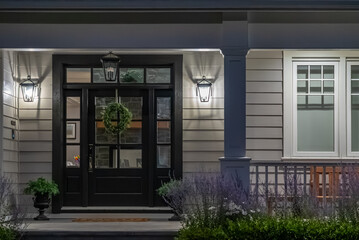 Entrance of luxury house with nice spring blossom landscape at night in Vancouver, Canada, North...