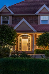 Entrance of luxury house with nice spring blossom landscape at night in Vancouver, Canada, North...
