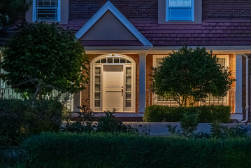 Entrance of luxury house with nice spring blossom landscape at night in Vancouver, Canada, North...