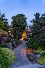Entrance of luxury house with nice spring blossom landscape at night in Vancouver, Canada, North...