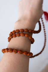  Japamala on the hand. Prayer beads. Religious equipment