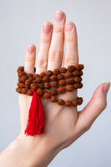  Japamala on the hand. Prayer beads. Religious equipment