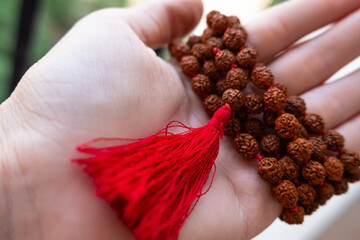  Japamala on the hand. Prayer beads. Religious equipment