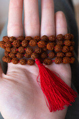 Japamala on the hand. Prayer beads. Religious equipment