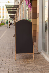 Chalk information board. Cafe or shop sidewalk wooden sign board. Mock up. Vertical