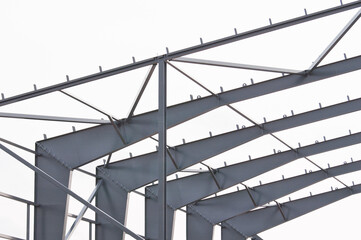 Metal construction, in the photo the structure of the building frame made of metal beams against...