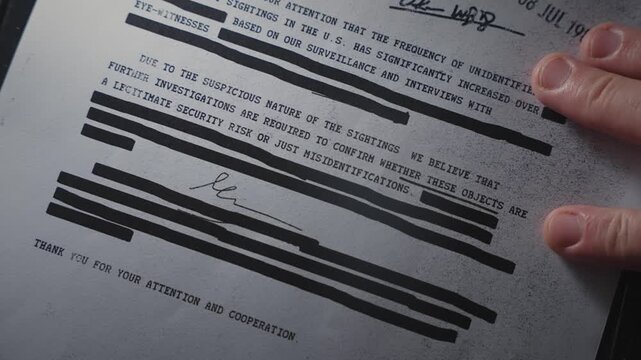 Top secret censored document file is placed on photocopy machine or scanner. Spy or whistleblower exposing and revealing classified information. Copying or sending sensitive government material