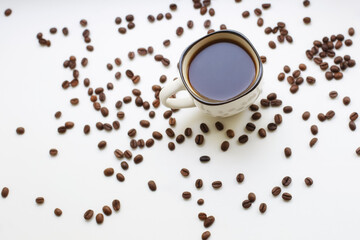 Coffee cup and coffee beans on a white background. A coffee house.