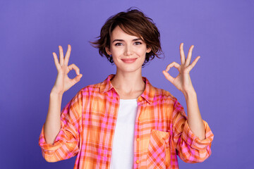 Portrait of nice young lady demonstrate okey symbol wear shirt isolated on purple color background