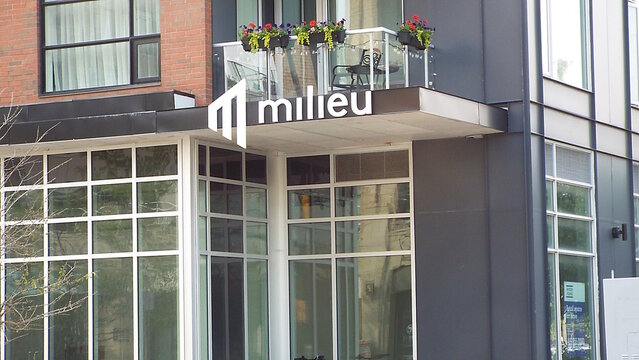 Ottawa, ON, Canada-July 13,2025 : The entrance of a building with the word "milieu" and a stylized "M" logo at 6 Des Oblats Ave.