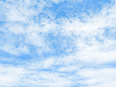 Clear blue sky with soft cloud with daylight natural background. Soft white clouds float in the clear blue sky. Clear blue sky, bright spring, soft sky gradient.