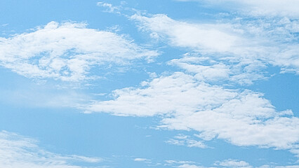 Clear blue sky with soft cloud with daylight natural background. Soft white clouds float in the clear blue sky. Clear blue sky, bright spring, soft sky gradient.